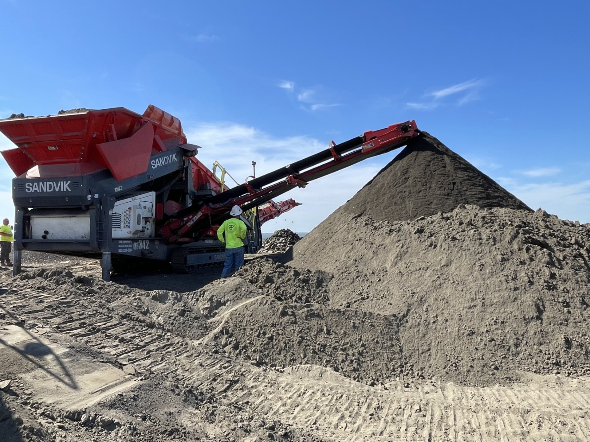 image of material being run through a landfill screen searching for artifacts