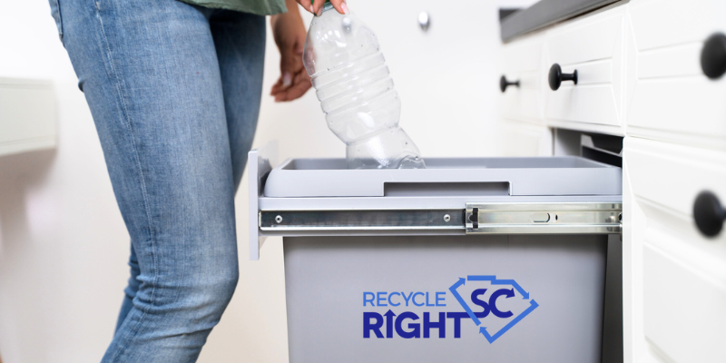 Woman puts bottle in Recycle Right SC bin