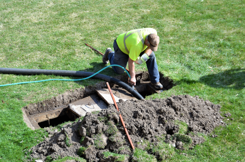 contractor working on septic tank