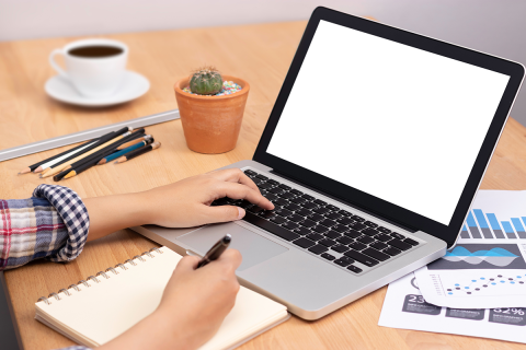 student using computer laptop with white blank screen for training online and writing lecture note in notebook